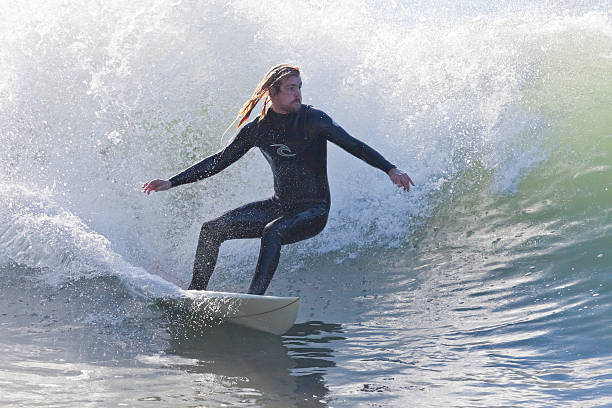 Athlete surfing on Santa Cruz beach in California stock photo