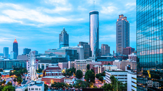 Skyline view of Downtown and Midtown Atlanta with ferris wheel from a rooftop bar and lounge