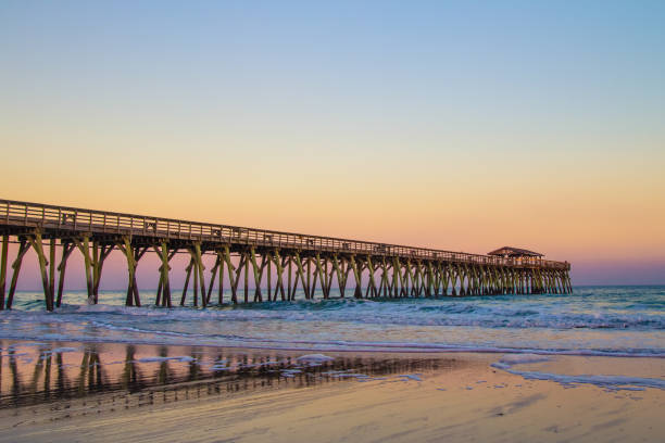 Atlantic Ocean Sunset And Long Wooden Pier Along The Grand Strand Coast In Myrtle Beach South Carolina stock photo
