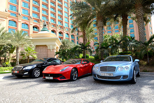 Atlantis the Palm hotel and limousines Dubai, UAE - September 11, 2013: The Atlantis the Palm hotel and limousines. It is located on man-made island Palm Jumeirah. luxury car stock pictures, royalty-free photos & images