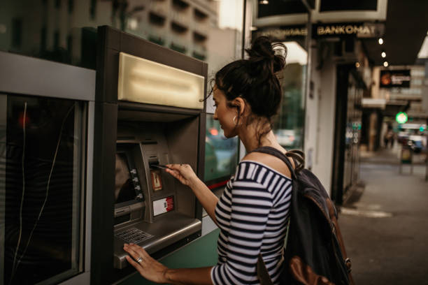 Atm Woman using ATM machine coin bank stock pictures, royalty-free photos & images