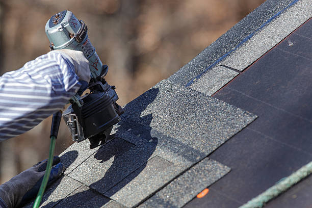 Attaching shingles to the roof. stock photo