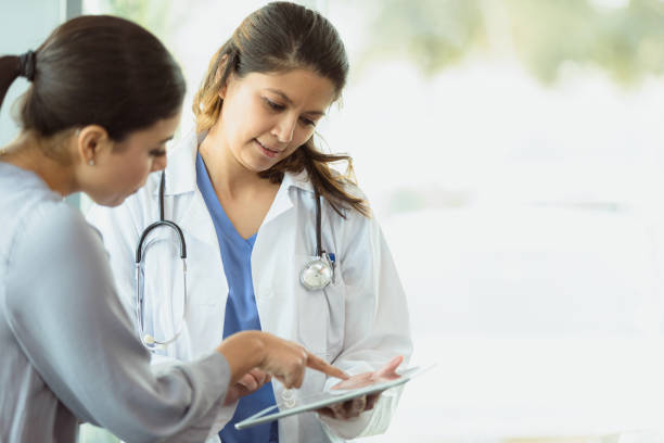 Attentive doctor discusses medical test result with patient stock photo