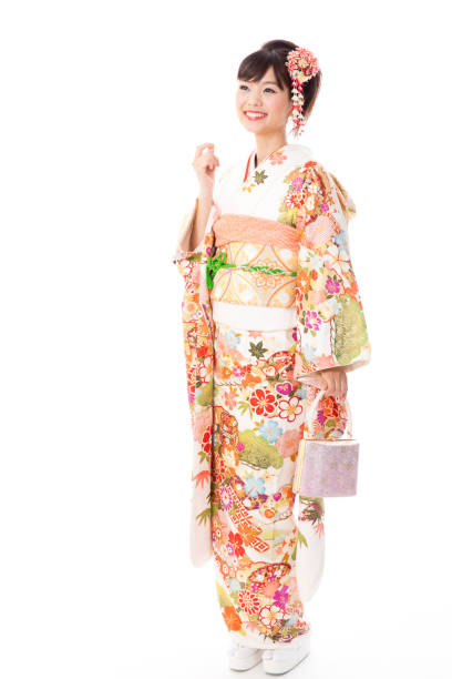 attractive asian woman wearing furisode isolated on white background attractive asian woman wearing furisode isolated on white background furisode stock pictures, royalty-free photos & images