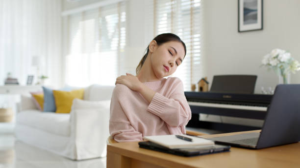 Attractive beautiful young asia female feel tired overworked negative impact health life stretching for break time relax stress relief in concept problem work remotely from home or burnout syndrome. stock photo