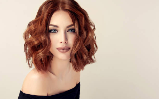 Attractive brown haired  woman  with modern, trendy and elegant hairstyle. Attractive brown haired  woman  with modern, trendy and elegant hairstyle. Example of middle length,dense and curly hair.Gentle make up and long eyelashes. wig stock pictures, royalty-free photos & images