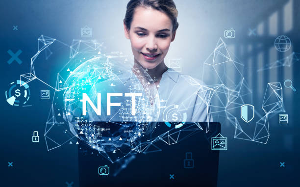 Attractive businesswoman working on laptop, non-fungible token hologram, nft with network circuit and globe. Concept of crypto art and technology stock photo