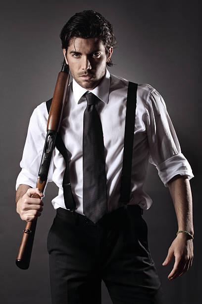 Attractive gangster with shotgun stock photo