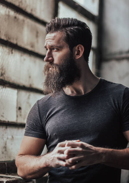 Attractive handsome man Young hipster man standing indoors macho stock pictures, royalty-free photos & images