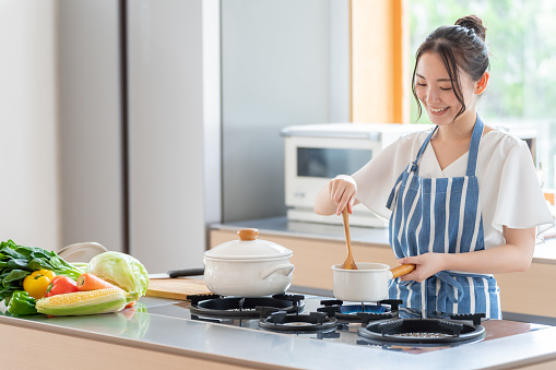 attractive japanese woman cooking in the kitchen
