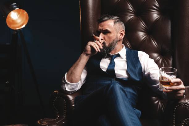 Elegant Man Drinking Scotch Whisky And Smoking Cigar Stock Photos ...