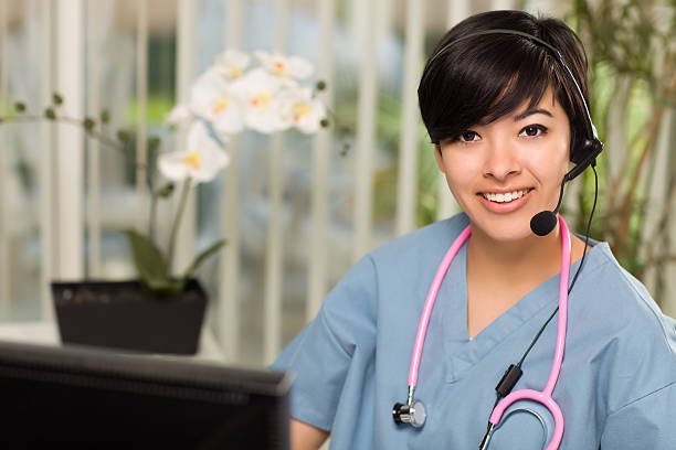 attractive multi-ethnic woman wearing headset, scrubs and stetho - happy scrubs nurse phone bildbanksfoton och bilder