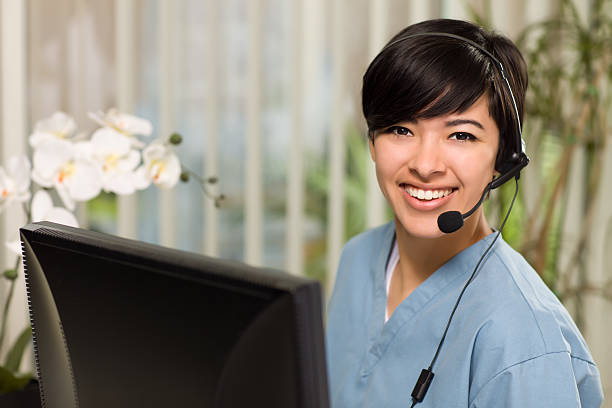 attractive multi-ethnic young woman wearing headset and scrubs - happy scrubs nurse phone bildbanksfoton och bilder