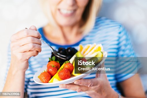 istock Attractive senior woman with fruit lunch 1187423906