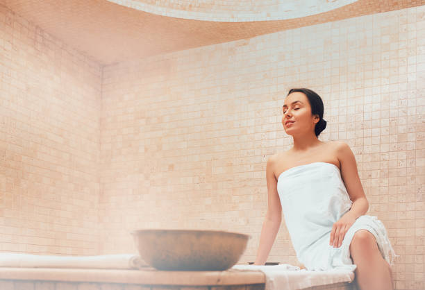 Attractive woman relaxing at hammam. Body recovery at hamam, traditional turkish bath Attractive woman relaxing at hammam. Body recovery at hamam, traditional turkish bath turkish bath photos stock pictures, royalty-free photos & images
