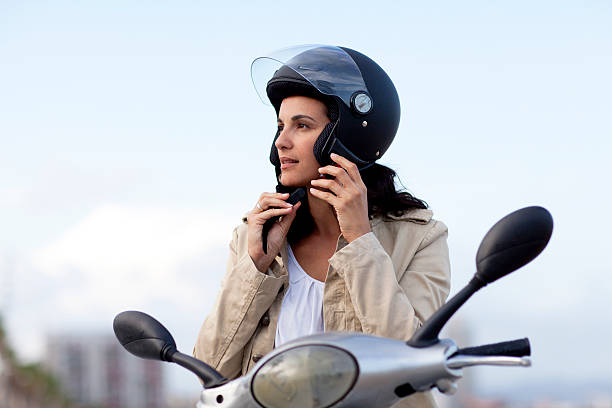 Attractive woman takes off her helmet stock photo