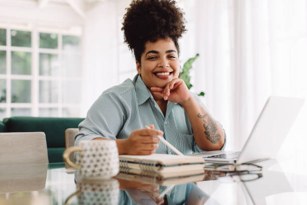 Attractive woman working from home stock photo