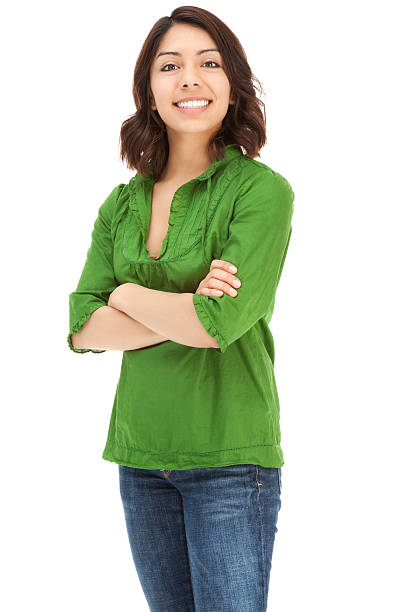 Attractive Young Casual Hispanic Woman Photo of an attractive young Hispanic woman in green pull-over shirt, standing with arms folded; isolated on white. mexican teenage girls stock pictures, royalty-free photos & images