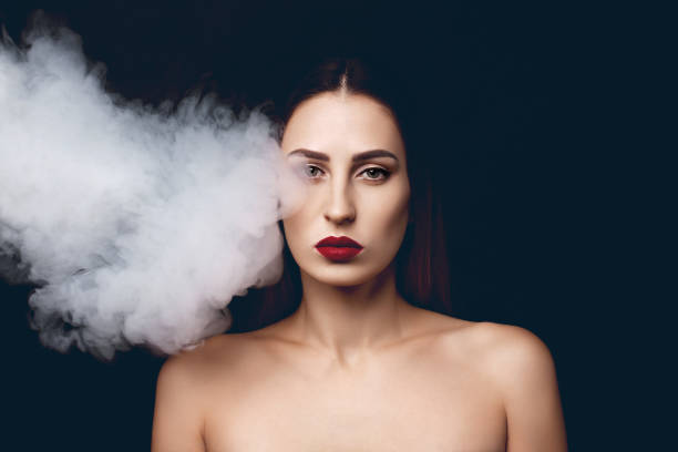 Attractive young girl and white smoke. stock photo