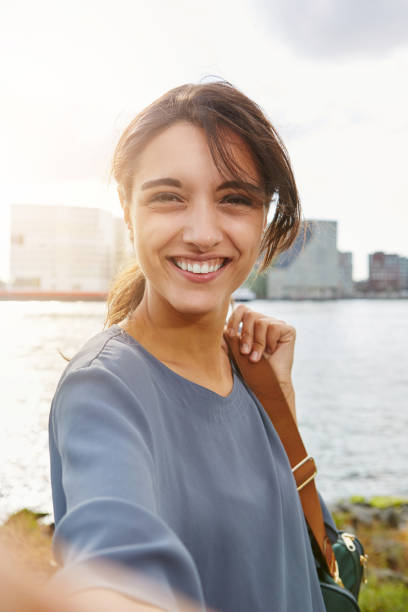 attractive young woman talking selfie and smiling stock photo