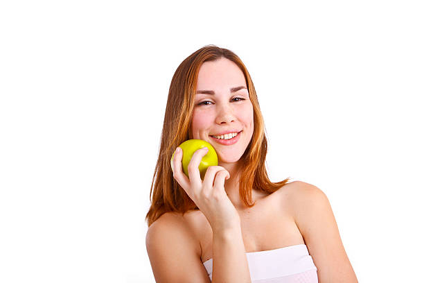 Attractive young woman with an apple stock photo