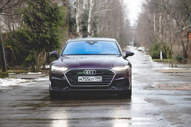 Audi A7 Sportback Ultra Nova GT 1 of 111 A purple-colored premium car stands in the street  front side view stock photo