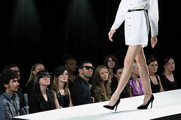 Audience watching model on catwalk at fashion show, low section  fashion runway stock pictures, royalty-free photos & images