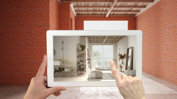 Augmented reality concept. Hand holding tablet with AR application used to simulate furniture and design products in interior construction site, wooden peaceful bathroom with bathtub stock photo