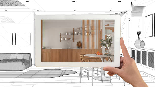 Augmented reality concept. Hand holding tablet with AR application used to simulate furniture products in custom architecture design, black ink sketch, living room and kitchen project stock photo