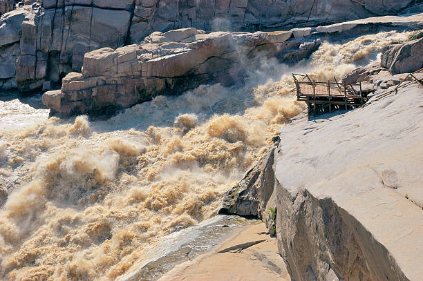 Augrabies Falls The Augrabies Falls in the Orange River showing viewing platform destroyed by flood augrabies falls national park stock pictures, royalty-free photos & images