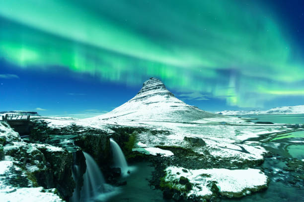 Aurora Borealis or northern light above kirkjufell mountain in iceland stock photo