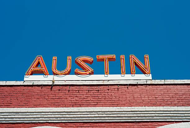 Austin Neon Sign "An orange neon sign for Austin sits atop an old red brick building in downtown Austin, Texas.  Shot with a Leica M8.Check out my other images of Austin, Texas:" austin texas stock pictures, royalty-free photos & images