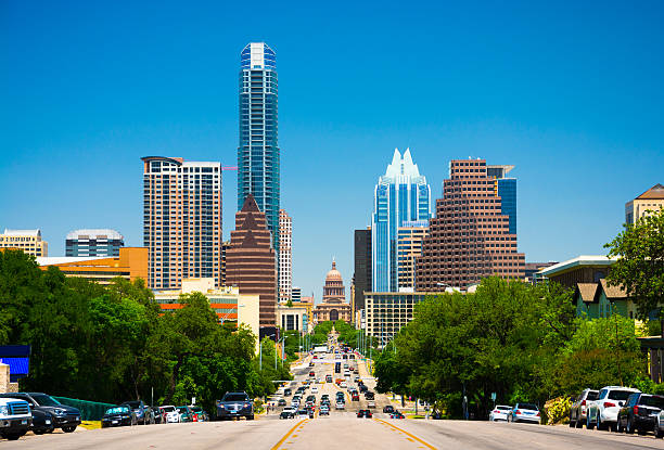 Austin skyline view with the Texas State Capitol Austin downtown skyline view and view down Congress Avenue with the Texas State Capitol building in view. avenue stock pictures, royalty-free photos & images