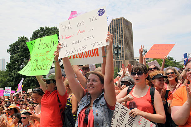 Austin, Texas Abortion Debate, July, 2013 Austin, TX, USA - July 1, 2013:  Pro-choice demonstrators express their position outside the Capitol.  Demonstrations were triggered by State Senator Wendy Davis' 11 hour filibuster to block Senate Bill 5, a measure intended to further restrict abortions. abortion protest stock pictures, royalty-free photos & images