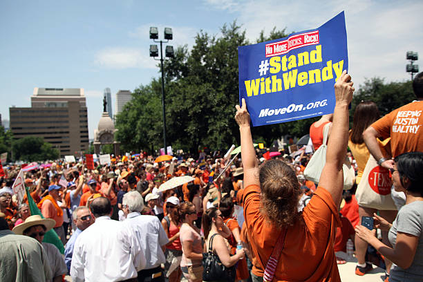 Austin, Texas Abortion Debate, July, 2013 Austin, TX, USA - July 1, 2013:  Pro-choice demonstrators express their position outside the Capitol.  Demonstrations were triggered by State Senator Wendy Davis' 11 hour filibuster to block Senate Bill 5, a measure intended to further restrict abortions. texas abortion stock pictures, royalty-free photos & images