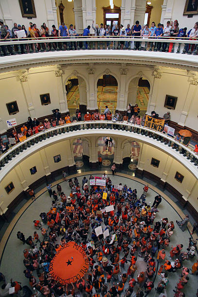 Austin, Texas Abortion Debate, July, 2013 Austin, TX, USA - July 12, 2013: Pro-choice and pro-life demonstrators express their positions under the dome of the Capitol the night that Senate Bill 5 finally passed. Demonstrations were triggered by State Senator Wendy Davis' 11 hour filibuster on June 25 to block the bill, a measure intended to further restrict abortions. texas abortion stock pictures, royalty-free photos & images