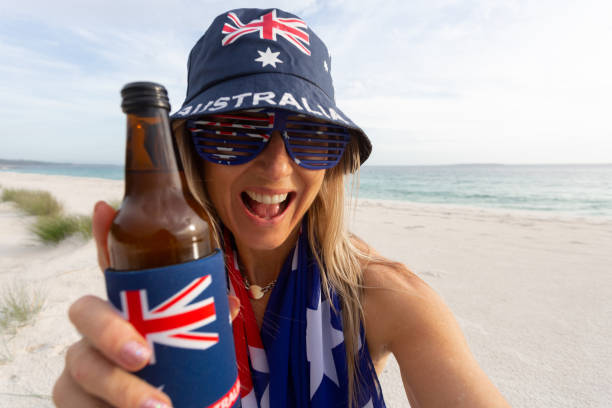 australian culture - lazy day on beach woman with a beer - cold beer beach prank imagens e fotografias de stock