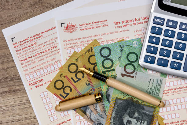 Australian dollars with calculator and tax form stock photo
