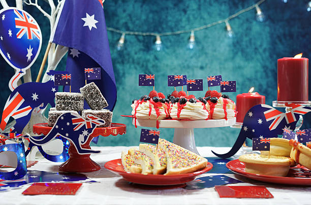 Australian theme party table with flags and iconic food Australian theme party table with flags and iconic food including mini pavlovas, lamingtons, meat pies and fairy bread. pavlova dessert photos stock pictures, royalty-free photos & images