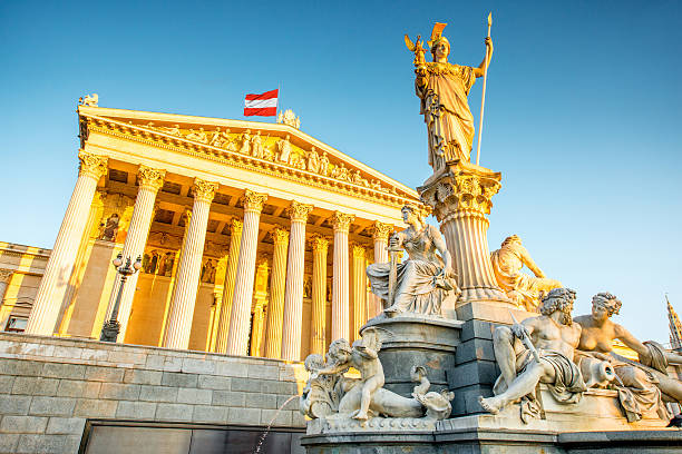 Austrian parliament building in Vienna Austrian parliament building with Athena statue on the front in Vienna on the sunrise vienna austria stock pictures, royalty-free photos & images
