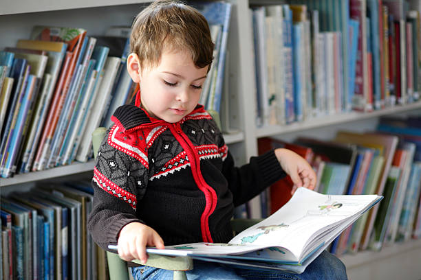 Autistic boy reading stock photo