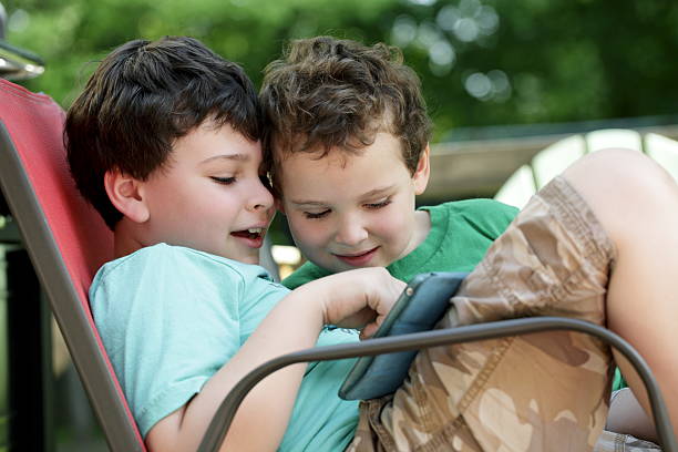 Autistic children share tablet experience stock photo