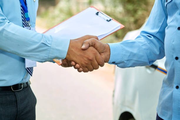 Auto loan deal handshaking close up between car loan agent and taxi driver Auto loan deal handshaking close up between car loan agent and taxi driver car loan stock pictures, royalty-free photos & images