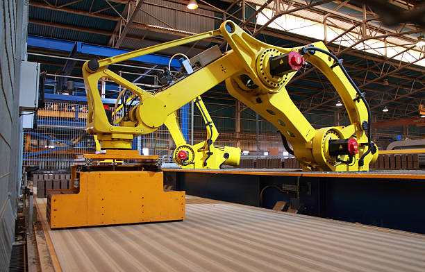 Automated manufacture production line robots picking up goods on conveyor stock photo