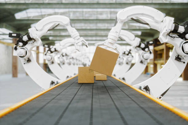 Automated Warehouse With Robotic Arms Automated factory with robotic arms carrying boxes. conveyor belt stock pictures, royalty-free photos & images