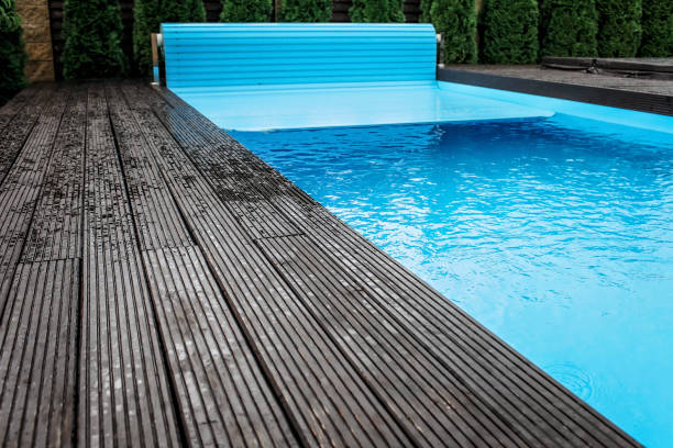 Automatic swimming pool covering system, home and cottage equipment stock photo
