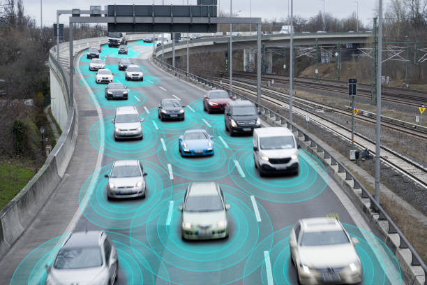 Photo illustration of autonomous self-driving cars using artificial intelligence to drive on a highway. They are connected through a network.