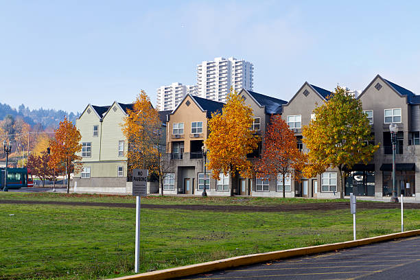 Autumn beauty in Portland, OR. "Portland, OR, USA - November 20, 2011: Housing fronted by some beautiful Autumn trees with highrise building in the background." neicebird stock pictures, royalty-free photos & images