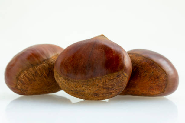 Autumn delicacies, chestnuts, white, white background stock photo