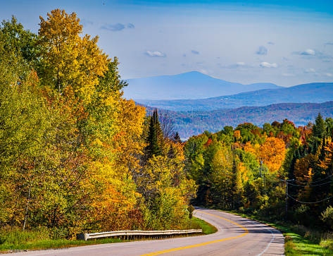a drive through the bright autumn foliage landscape in the Vermont countryside